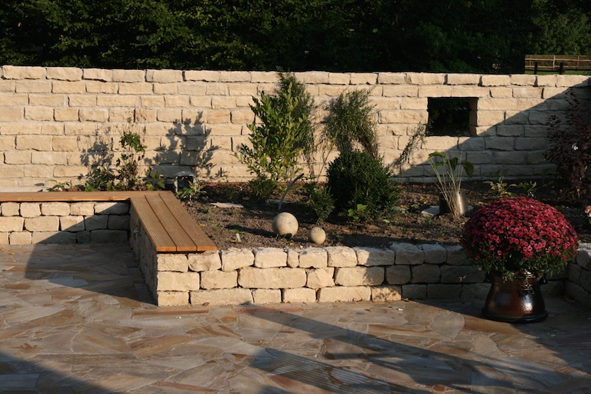 Gemauerte Jura Mauer als massiver Sichtschutz und Trockenmauer aus Jura als Beeteinfassung und Sitzm&ouml;glichkeit. (Freising)